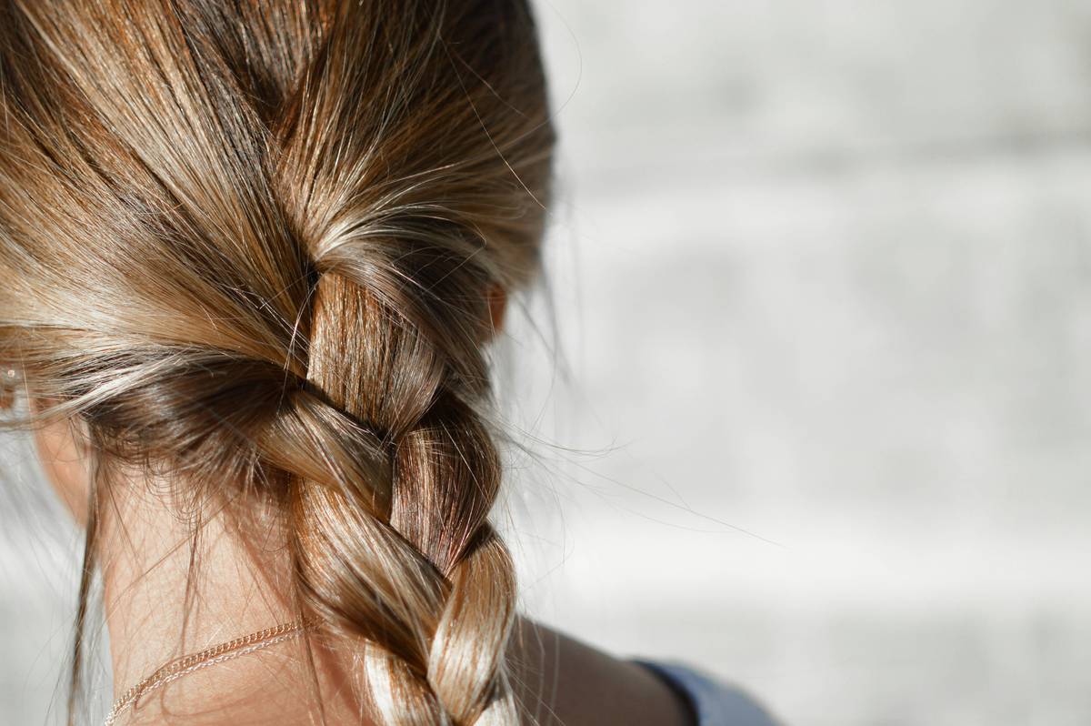Close-up of healthy smooth hair styling showing natural shine and movement
